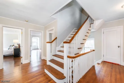 a view of entryway and hall with wooden floor