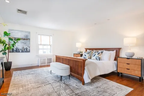 a spacious bedroom with a bed and a window