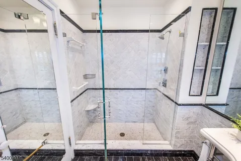 a bathroom with a glass shower door and a window
