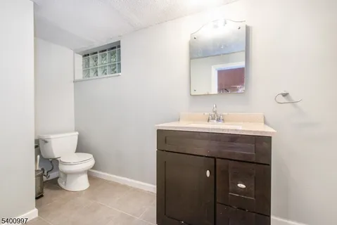 a bathroom with a sink toilet and mirror