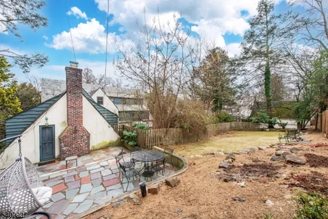 a view of a backyard with chairs
