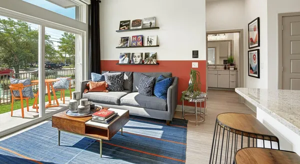 a living room with furniture and a floor to ceiling window