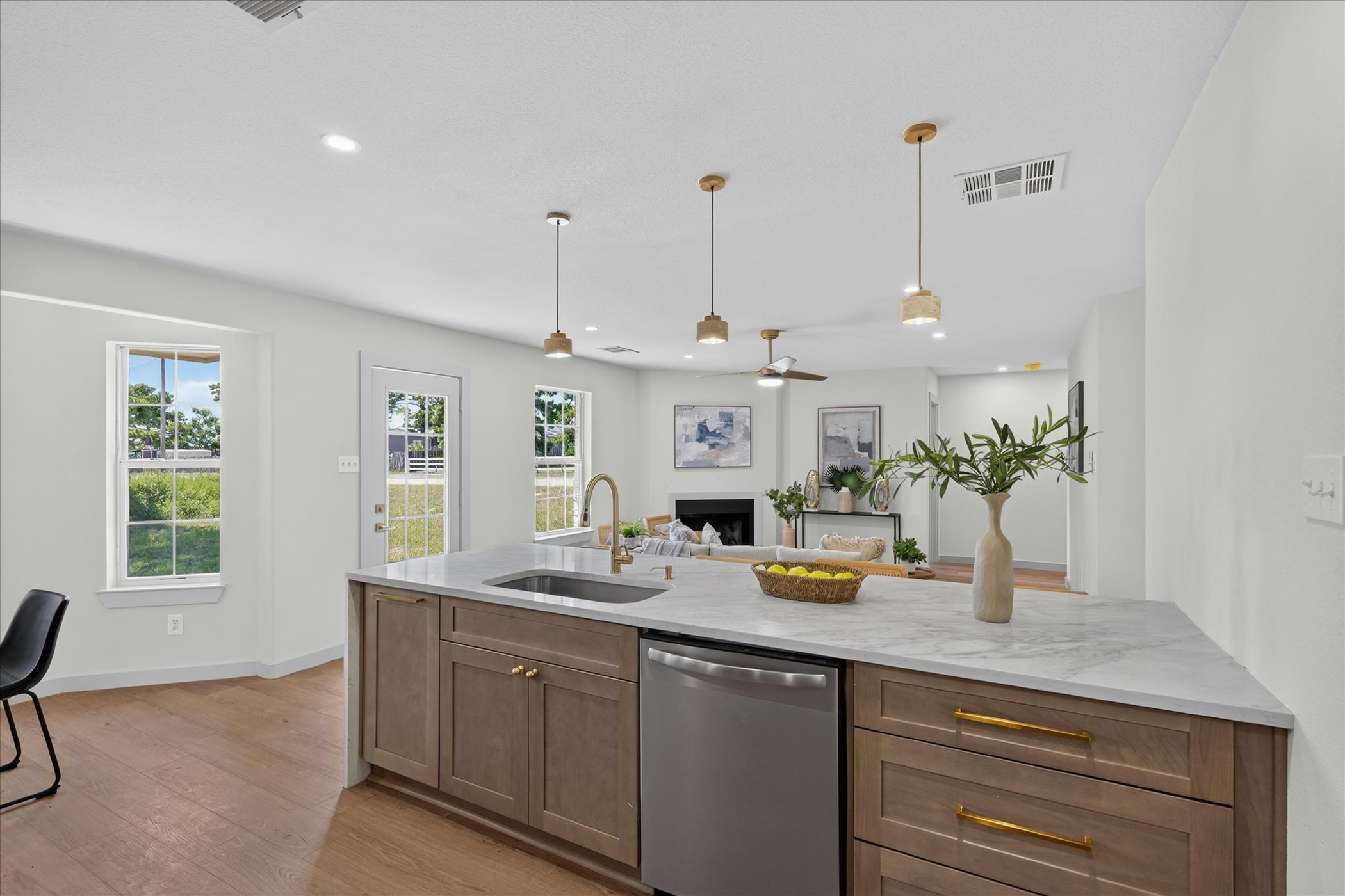 258 Pine View Loop Bastrop, TX 78602 - Photo 26 of 40 A well-lit kitchen island with sleek countertops anchors an open-concept living space.