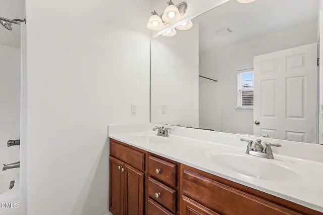 a bathroom with a sink vanity and a mirror