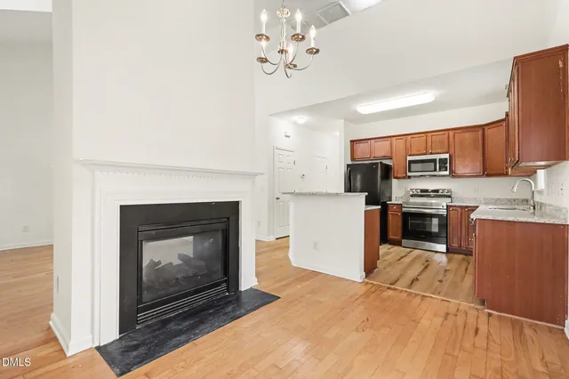 a kitchen with granite countertop a stove top oven and cabinets