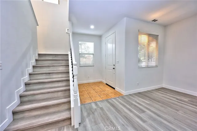 a view of wooden floor and windows in a room
