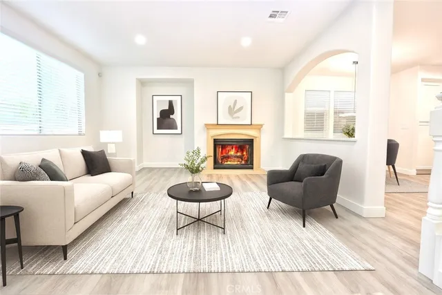 a living room with furniture and a wooden floor