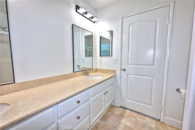 a spacious bathroom with a granite countertop sink mirror and