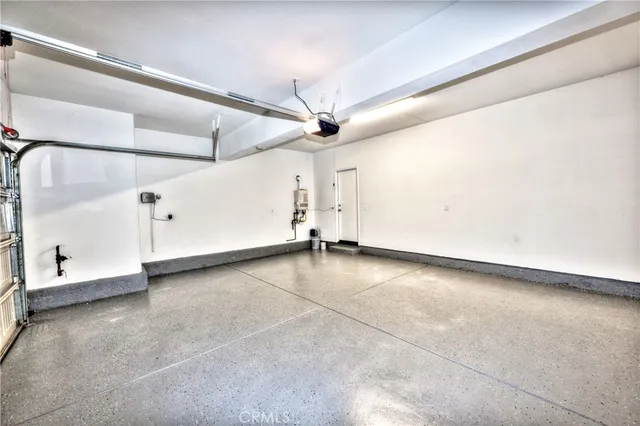 an empty room with a ceiling fan and window