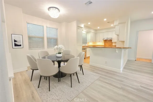 a dining room with furniture and wooden floor