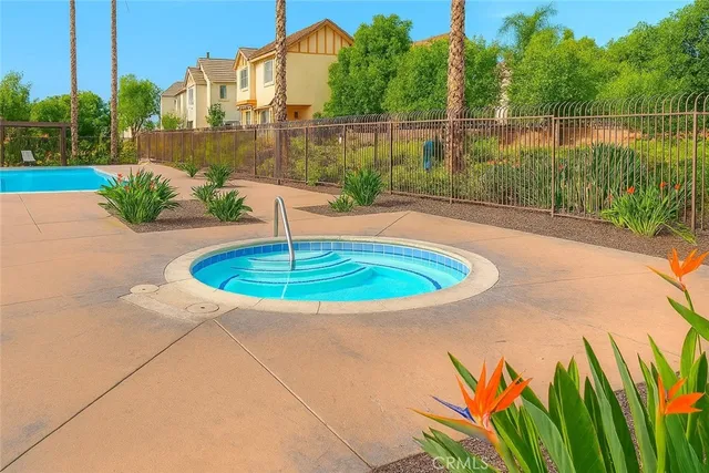 a view of a patio with a table chairs potted plants and a palm tree