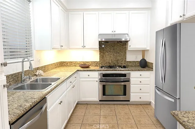 a kitchen with a sink stove and refrigerator