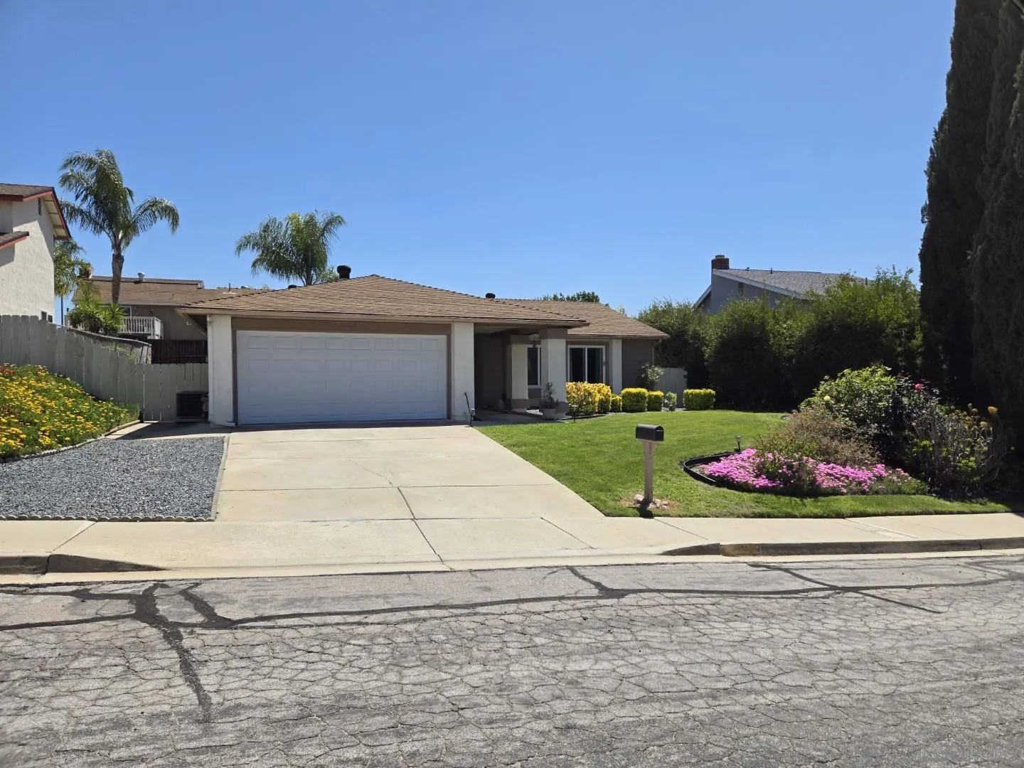 9343 Lake Hill Road Santee, CA 92071 - Photo 1 of 23 a front view of a house with a garden