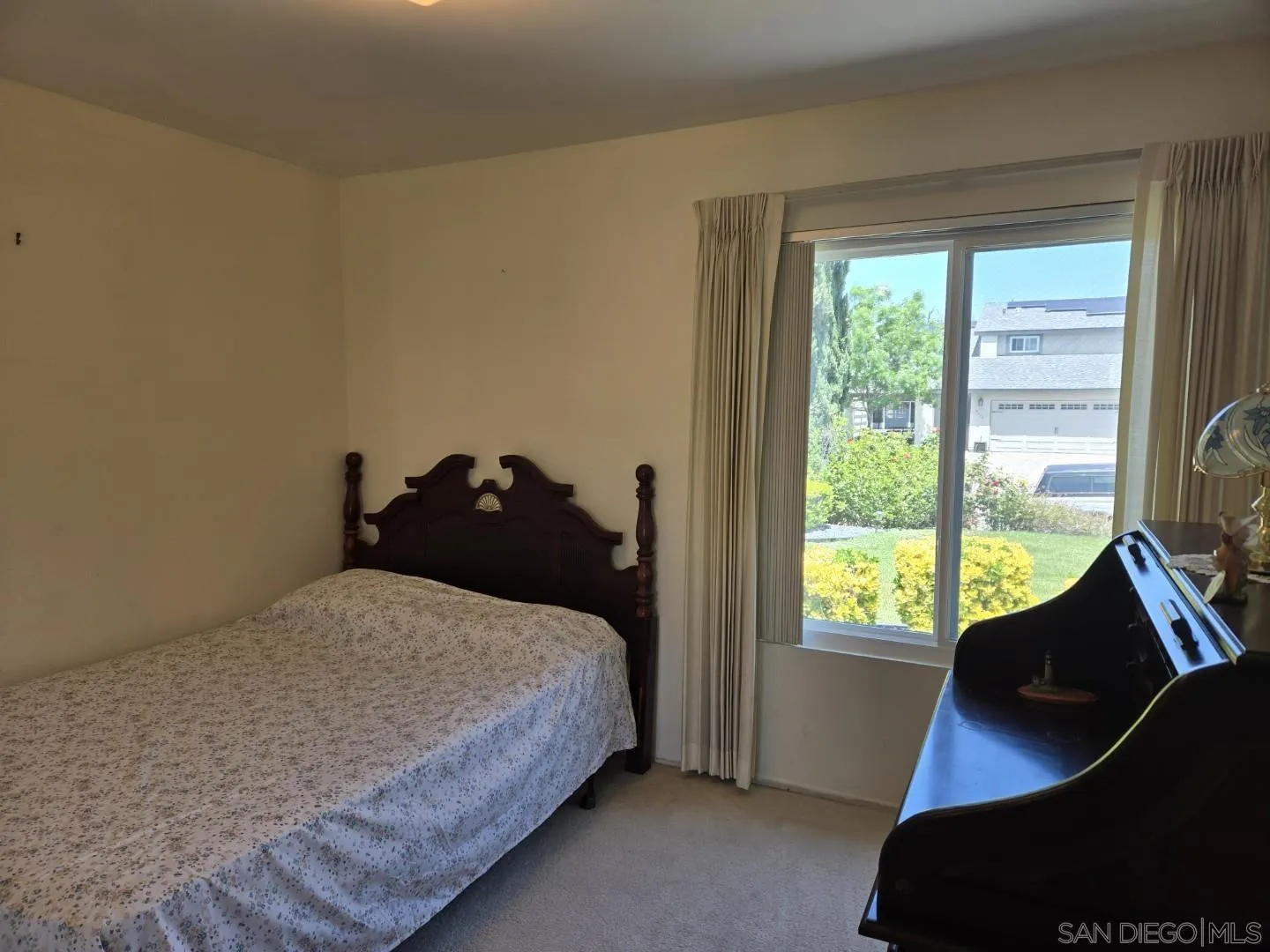 9343 Lake Hill Road Santee, CA 92071 - Photo 15 of 23 a bedroom with a bed and a large window