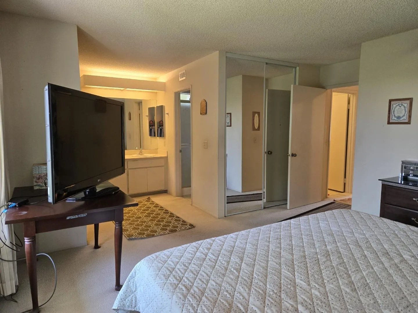 9343 Lake Hill Road Santee, CA 92071 - Photo 18 of 23 a bedroom with a bed and a flat screen tv