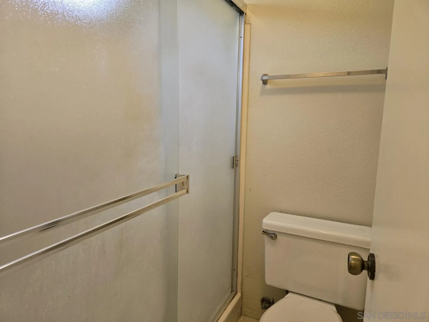 9343 Lake Hill Road Santee, CA 92071 - Photo 19 of 23 a white toilet sitting next to a shower