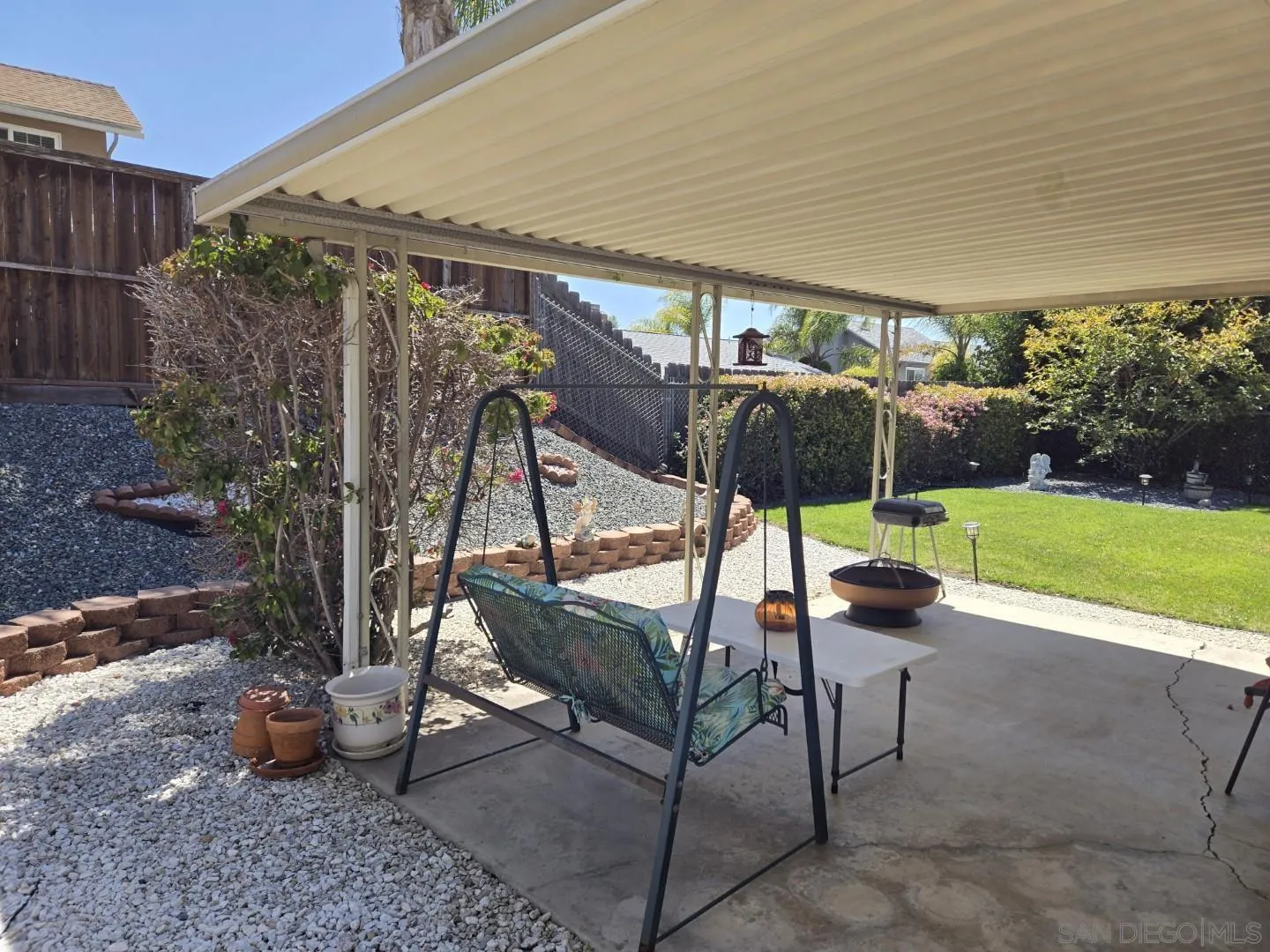 9343 Lake Hill Road Santee, CA 92071 - Photo 20 of 23 a view of a patio with a table and chairs under an umbrella