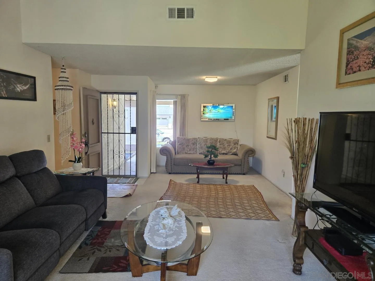 9343 Lake Hill Road Santee, CA 92071 - Photo 4 of 23 a living room with furniture a flat screen tv and a window