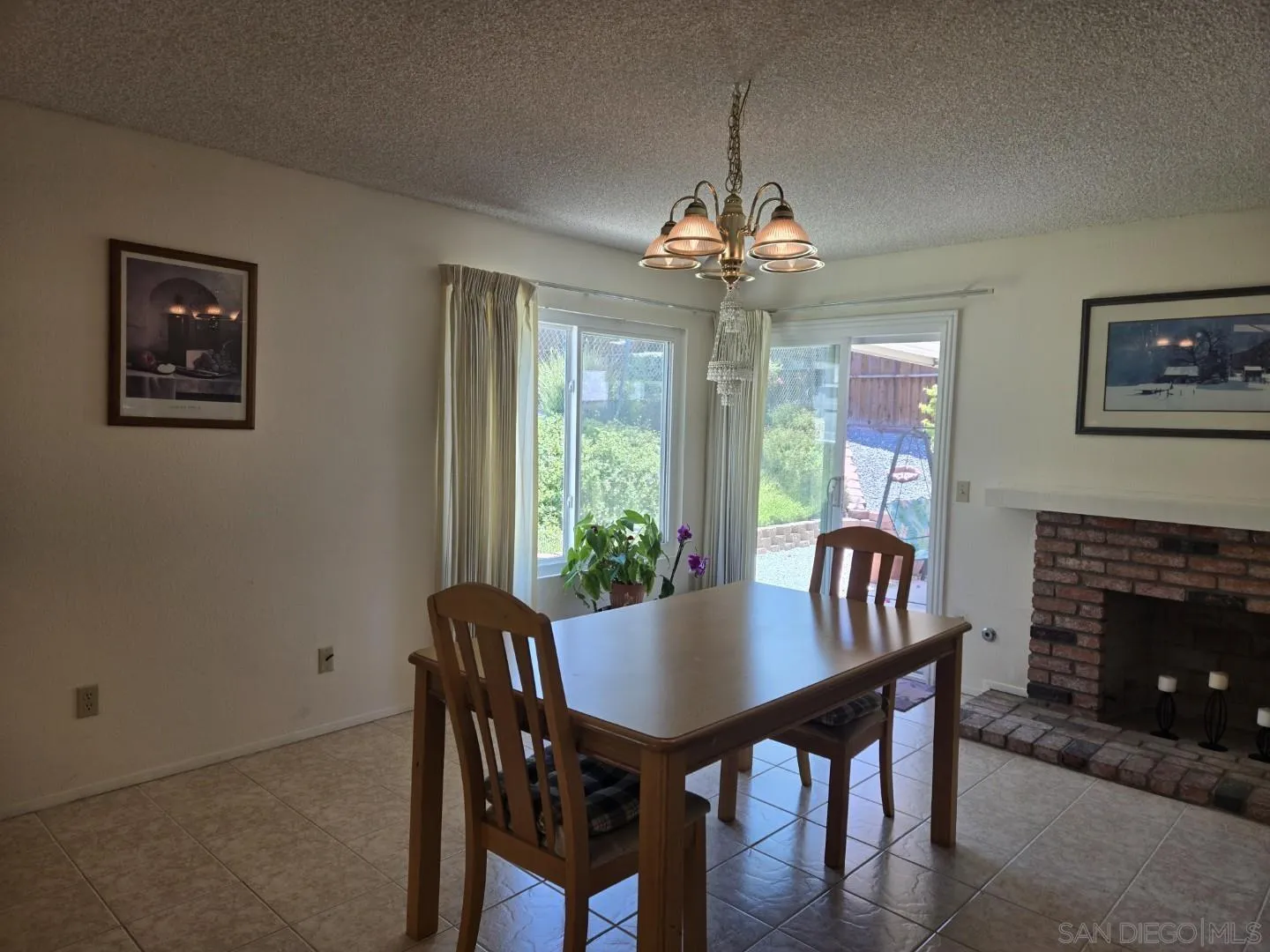 9343 Lake Hill Road Santee, CA 92071 - Photo 5 of 23 a view of a dining room with furniture a chandelier window and wooden floor