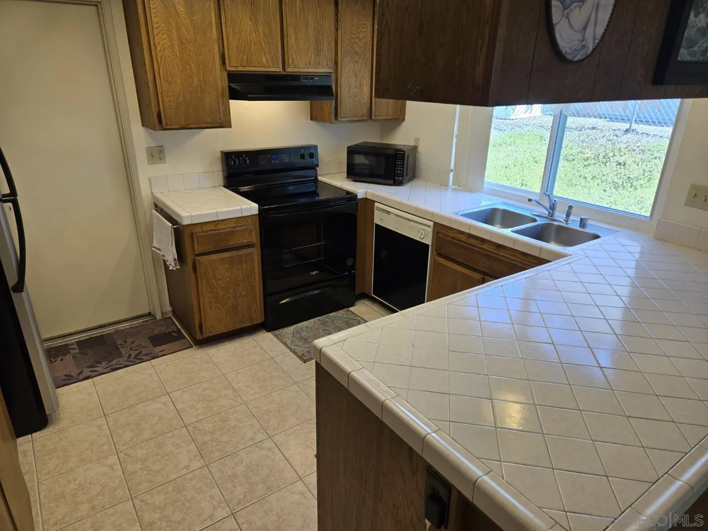 9343 Lake Hill Road Santee, CA 92071 - Photo 6 of 23 a kitchen with a sink appliances and cabinets