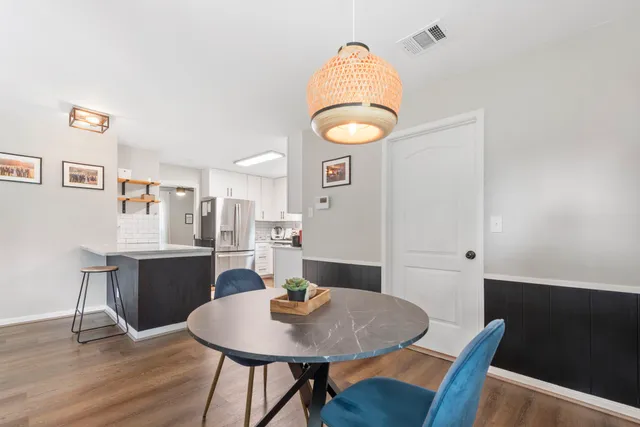 a view of a dining room with furniture and wooden floor