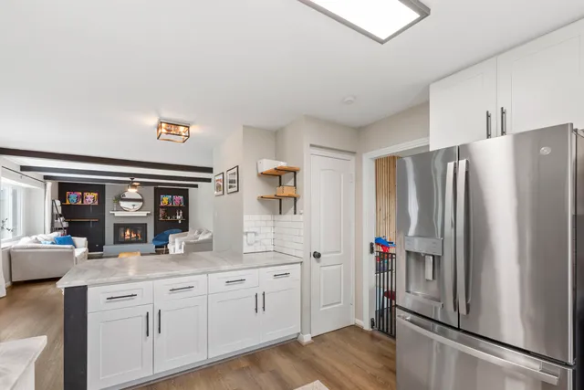 a kitchen with stainless steel appliances a refrigerator and cabinets