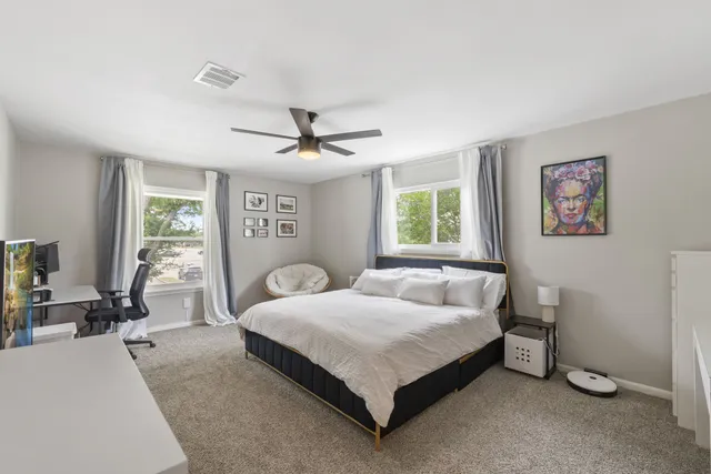 a bedroom with a bed a table and chair