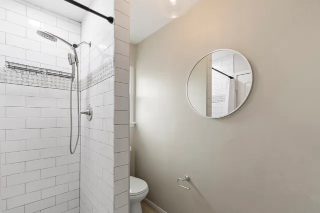 a bathroom with a toilet and a shower