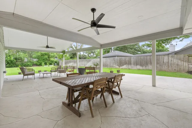a backyard of a house with table and chairs