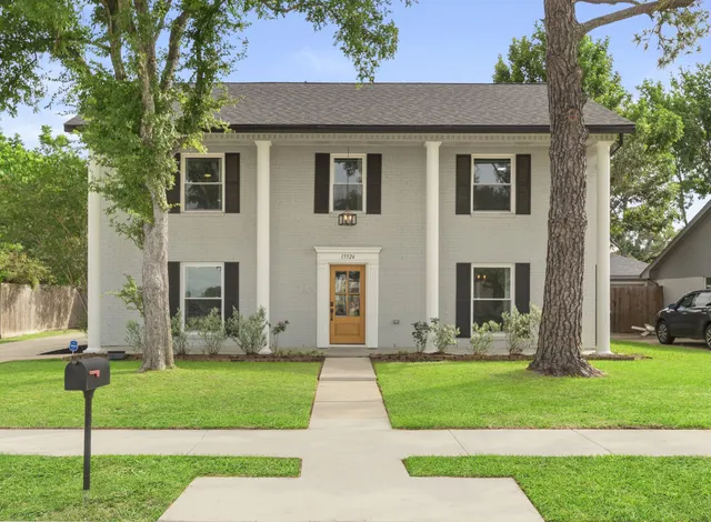 a front view of house with yard and green space