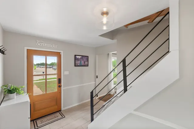 a view of an entryway with wooden floor and door