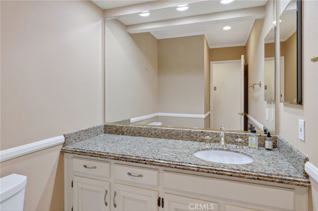 28741 Springfield Drive Laguna Niguel, CA 92677 - Photo 12 of 34 a bathroom with a granite countertop sink and a mirror