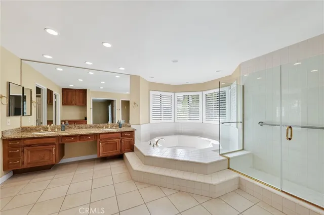 a large bathroom with a large tub and sink