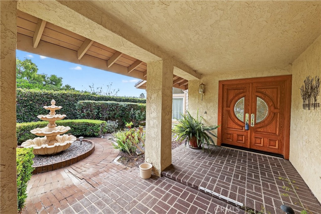 28741 Springfield Drive Laguna Niguel, CA 92677 - Photo 2 of 34 a view of a patio with table and chairs potted plants with floor to ceiling window