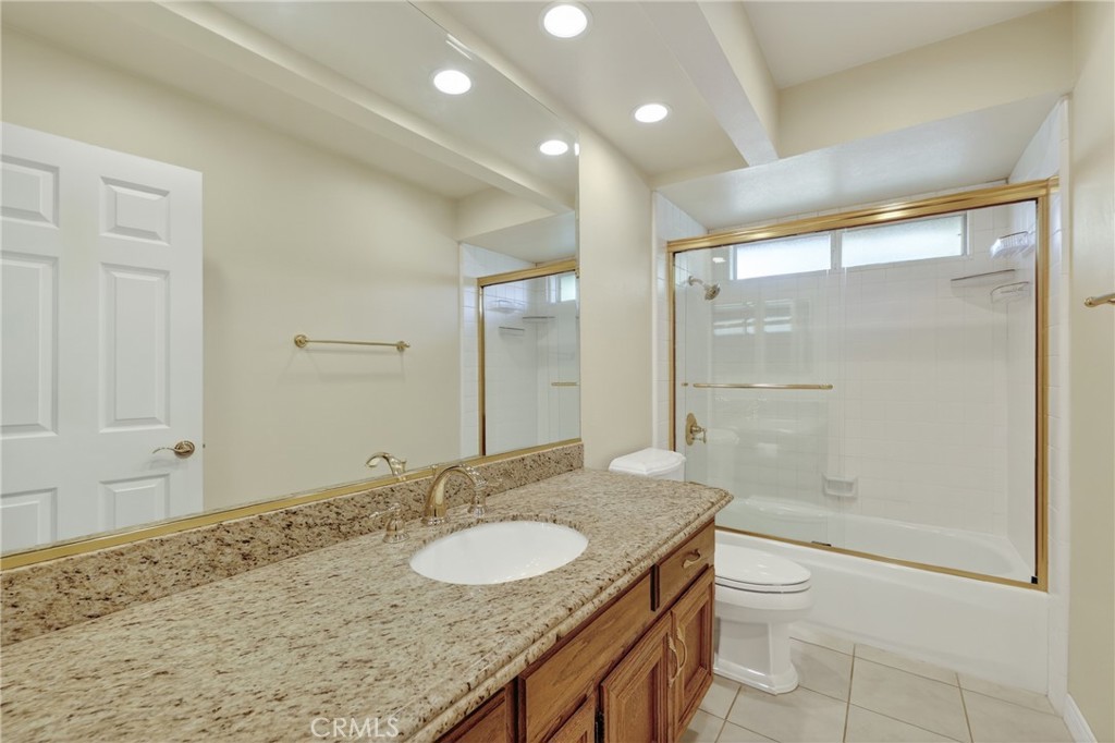 28741 Springfield Drive Laguna Niguel, CA 92677 - Photo 24 of 34 a bathroom with a granite countertop sink a toilet and shower