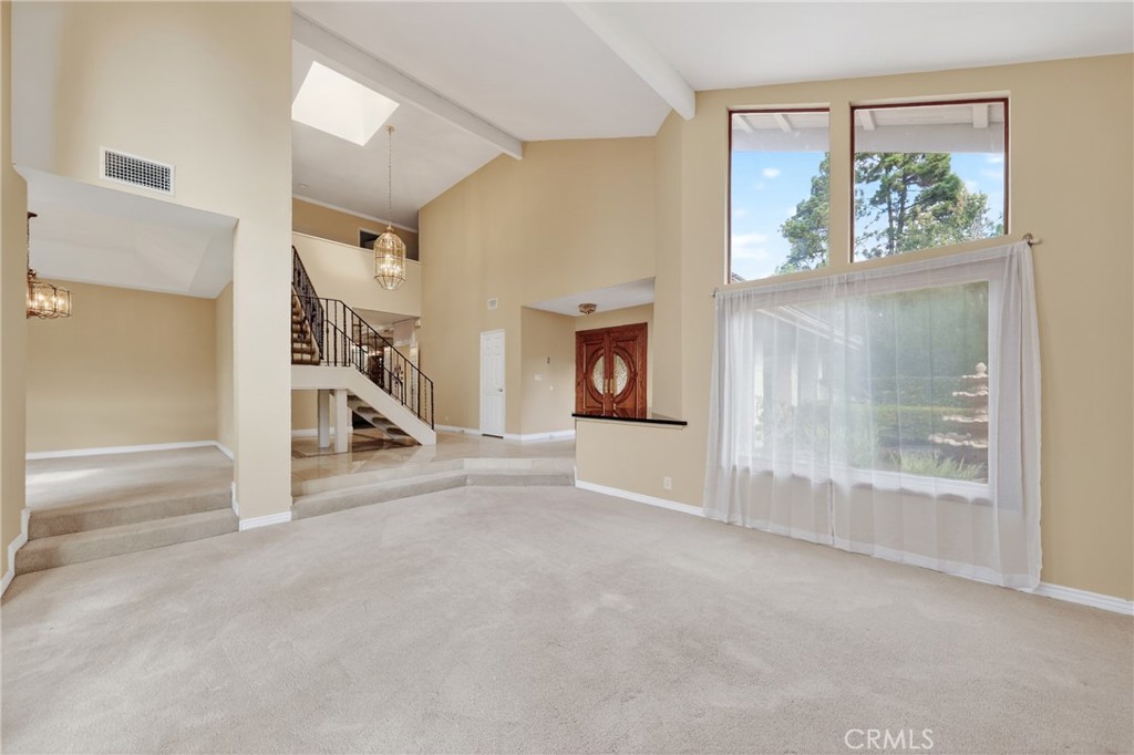 28741 Springfield Drive Laguna Niguel, CA 92677 - Photo 5 of 34 an empty room with floor to ceiling windows and a fireplace