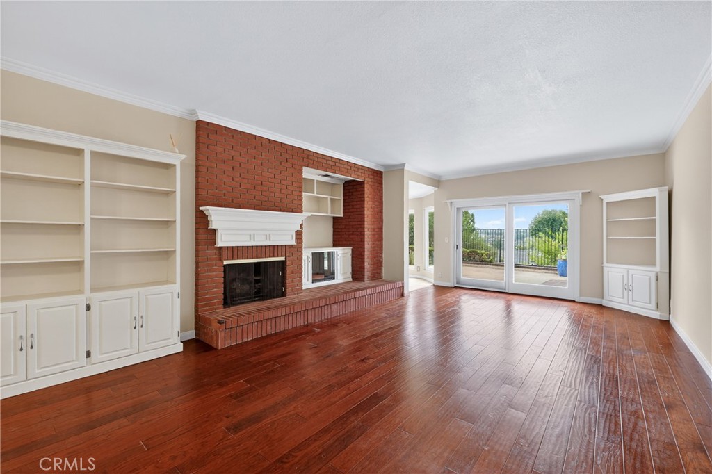 28741 Springfield Drive Laguna Niguel, CA 92677 - Photo 9 of 34 an empty room with wooden floor fireplace and windows