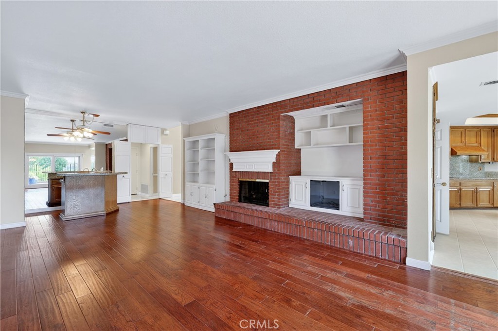 28741 Springfield Drive Laguna Niguel, CA 92677 - Photo 10 of 34 a view of a livingroom with wooden floor and a fireplace