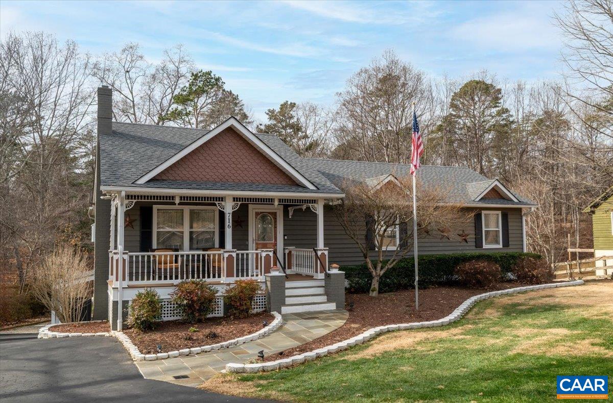 a view of a house with backyard porch and sitting area
