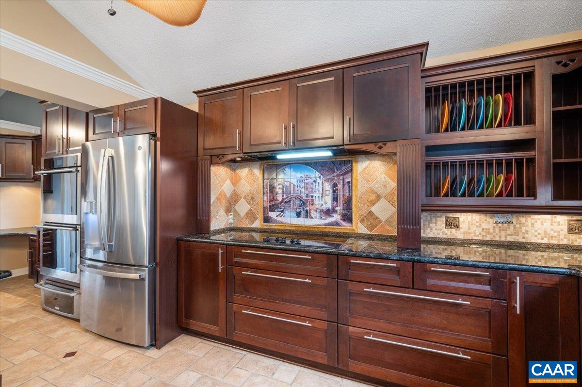 716 Preddy Creek Road Barboursville, VA 22923 - Photo 11 of 73 a kitchen with stainless steel appliances granite countertop a refrigerator and a wooden cabinets