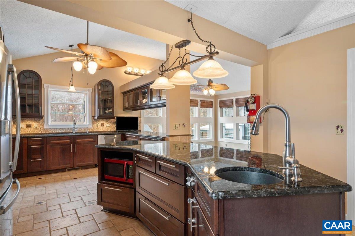 716 Preddy Creek Road Barboursville, VA 22923 - Photo 14 of 73 a kitchen with stainless steel appliances granite countertop a sink a stove and a wooden floors
