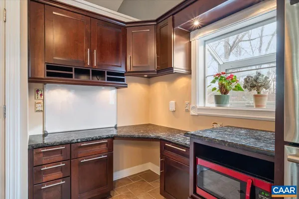 a kitchen with granite countertop a stove and a sink