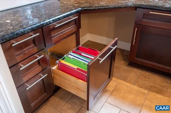 a kitchen with stainless steel appliances granite countertop a refrigerator and a stove