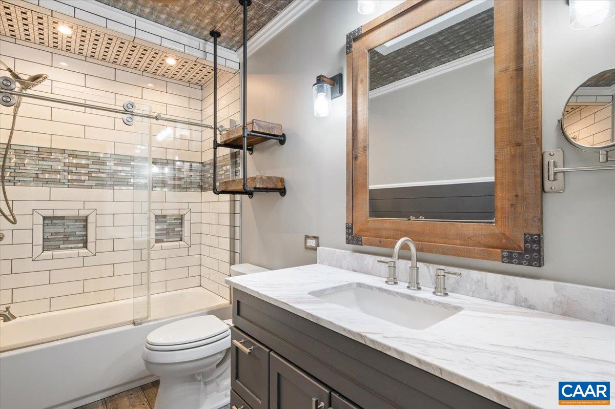 716 Preddy Creek Road Barboursville, VA 22923 - Photo 26 of 73 a bathroom with a granite countertop sink toilet and shower