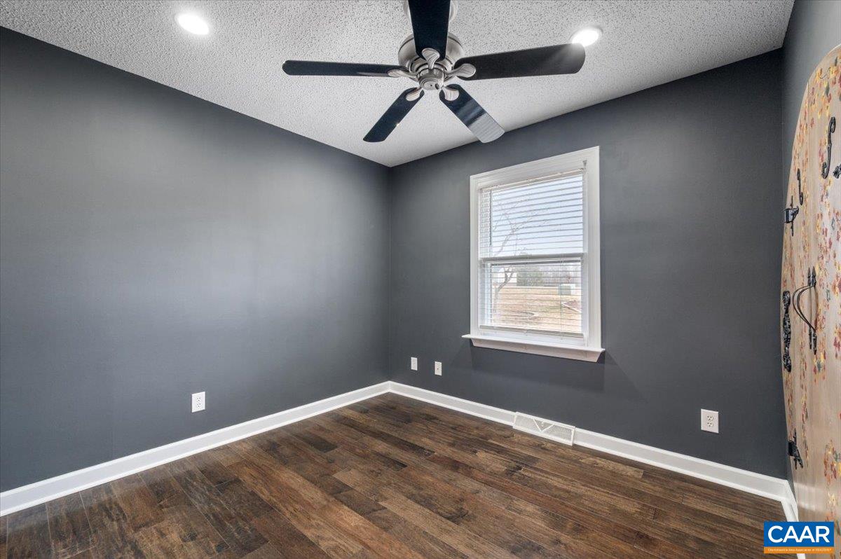 716 Preddy Creek Road Barboursville, VA 22923 - Photo 32 of 73 an empty room with a window and a fan