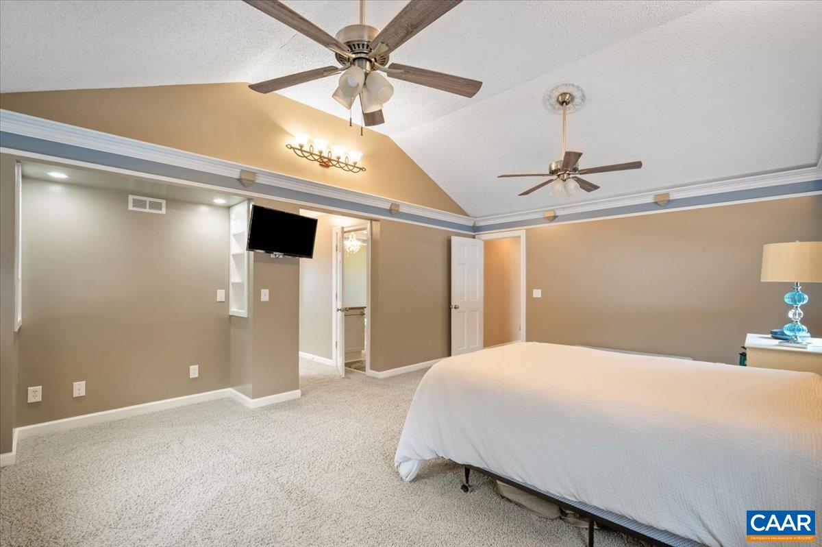 716 Preddy Creek Road Barboursville, VA 22923 - Photo 36 of 73 a bedroom with a large bed and a chandelier