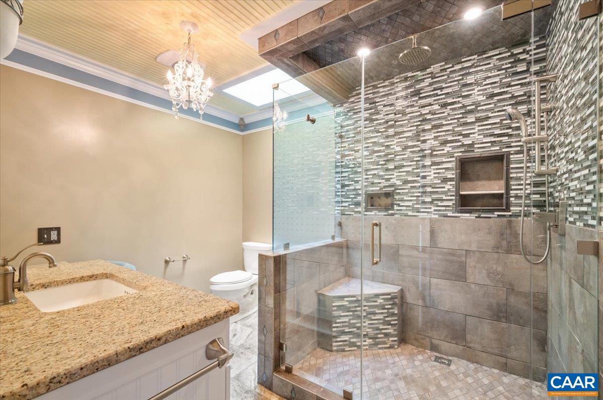 716 Preddy Creek Road Barboursville, VA 22923 - Photo 37 of 73 a bathroom with a granite countertop sink a mirror and shower