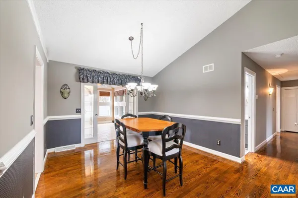 a dining room with furniture and chandelier