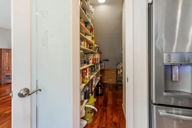 a dining room with furniture a chandelier and wooden floor