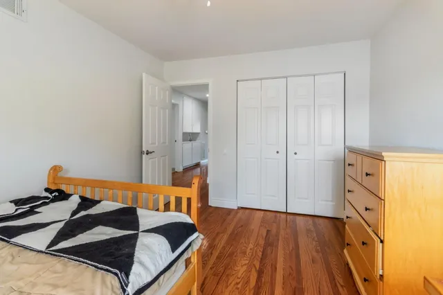 a large bed sitting in a bedroom next to a window
